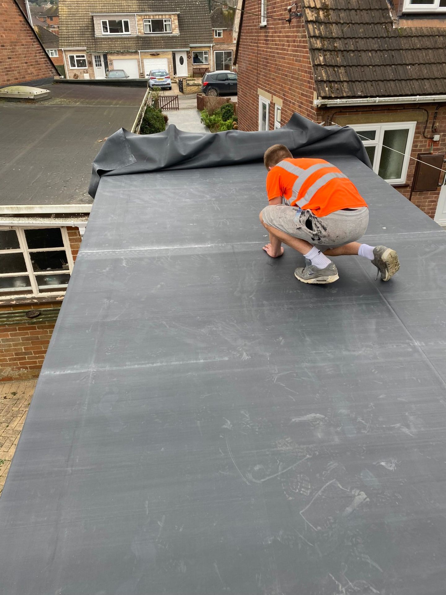 EPDM rubber membrane flat roof being installed on a domestic extension