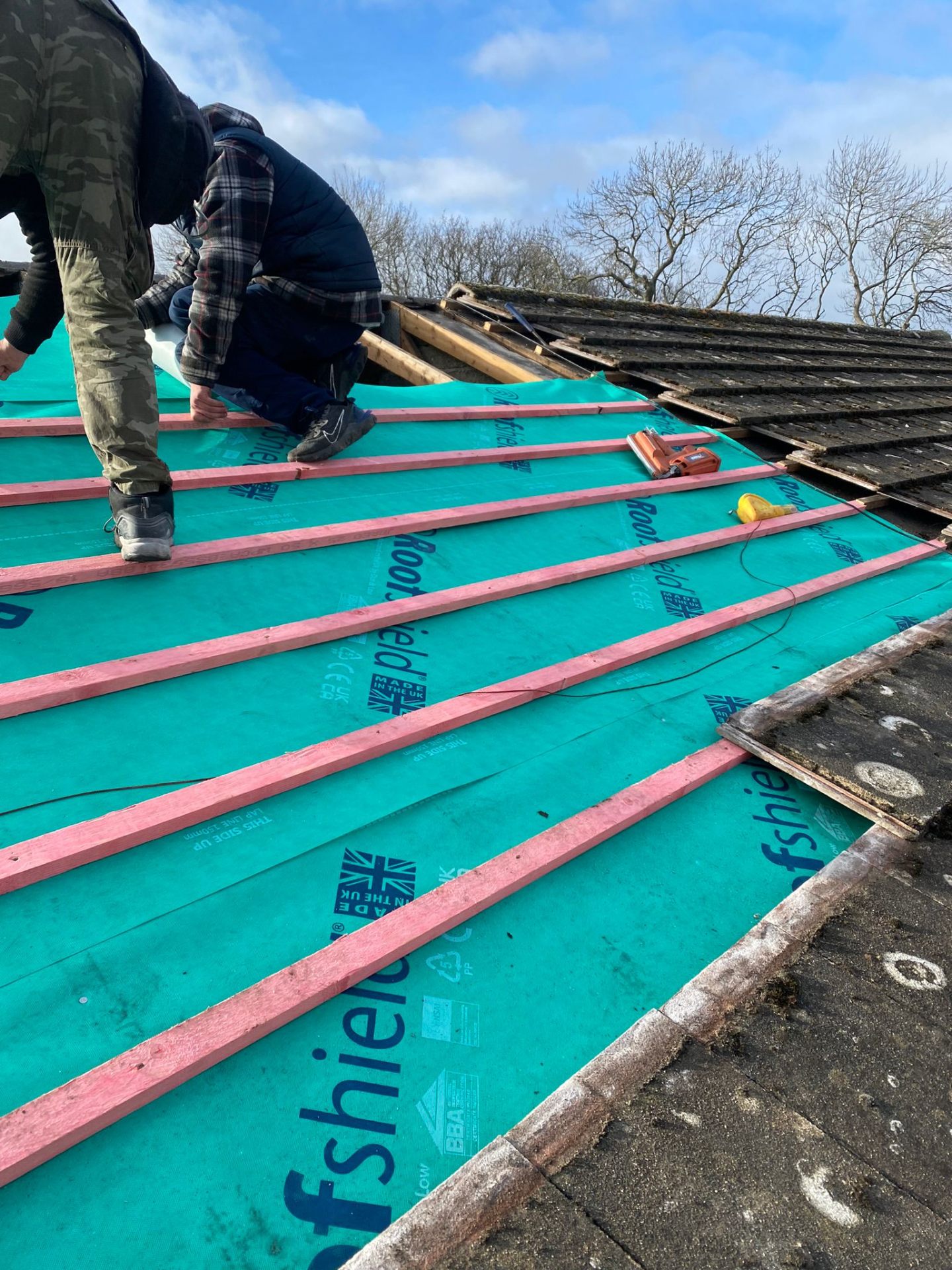 Roofshield breathable membrane being fitted with new battens during a re-roofing project