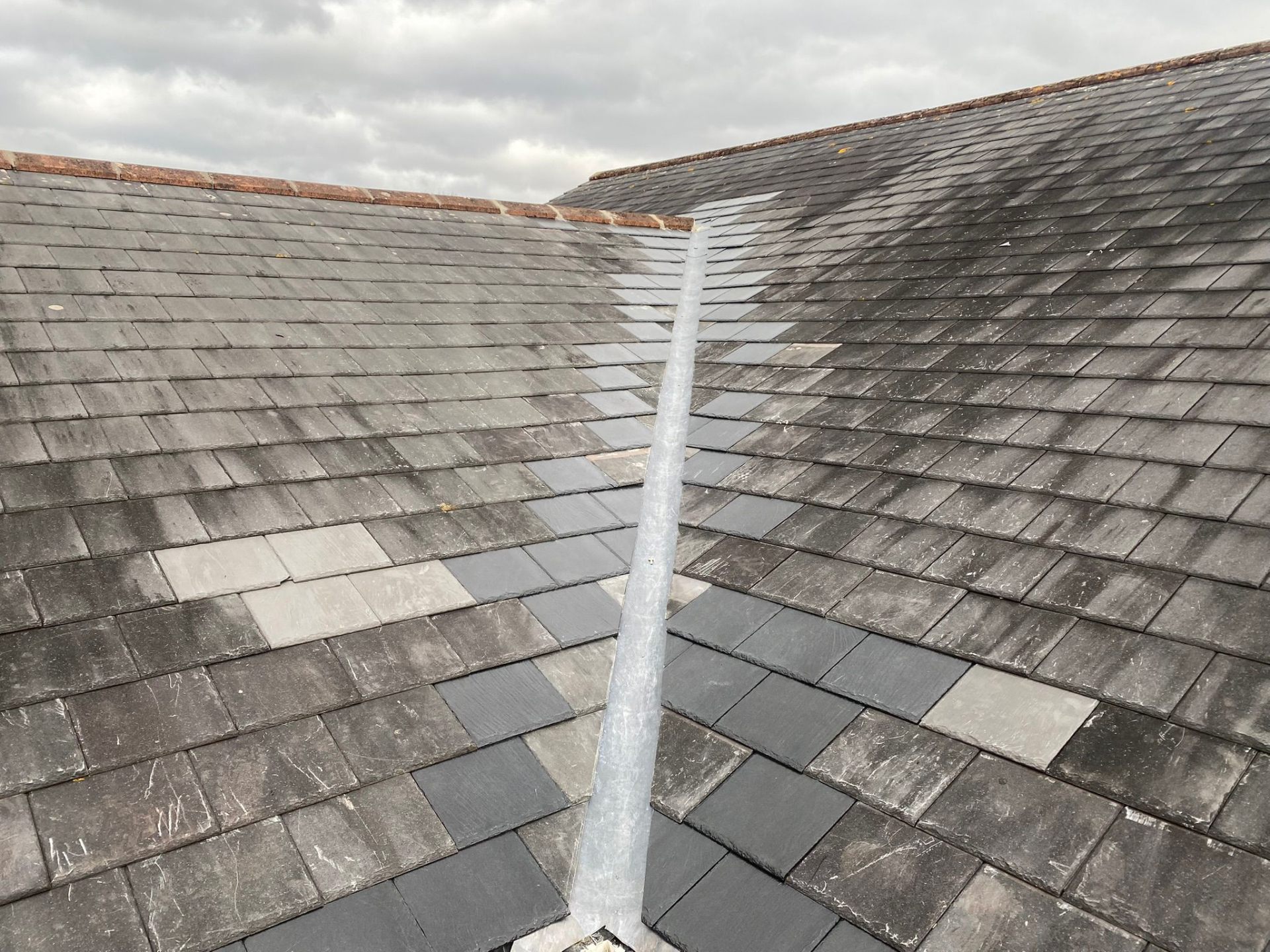 Slate roof valley with new lead flashing showing expert valley repair work